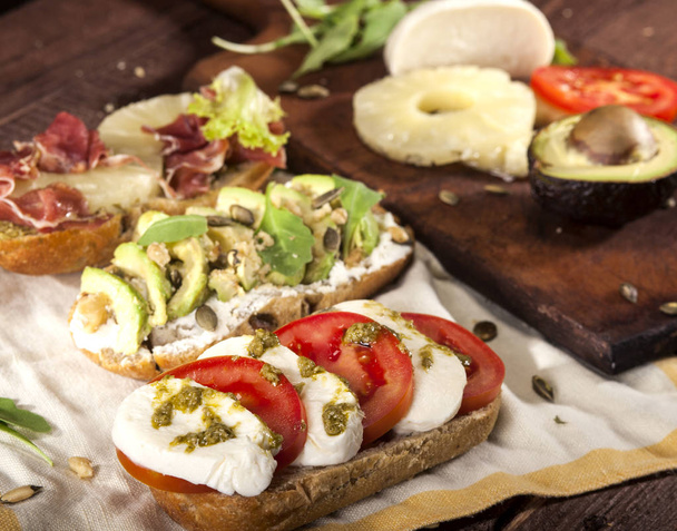 Collection of three diferent kinds of bruschetta on wooden table background. - Foto, afbeelding