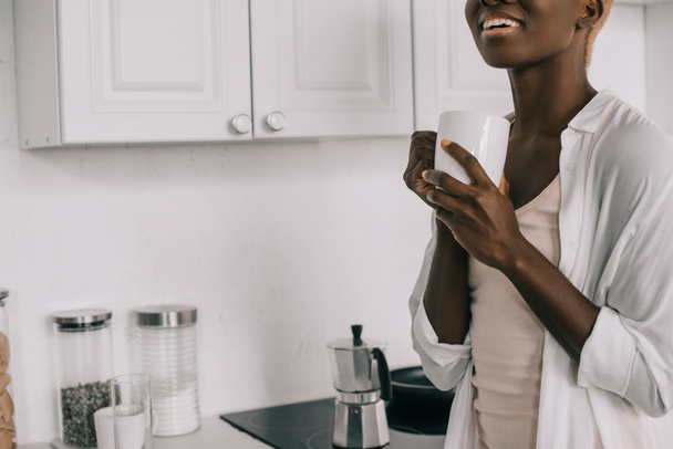 cropped view of cheerful african american woman with cup of coffee - Fotoğraf, Görsel