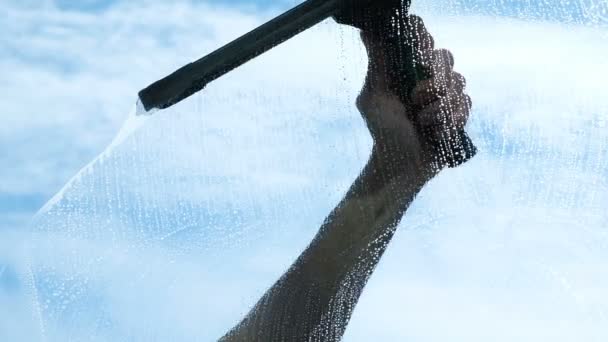 Hand cleans the wiper with a dirty window from the outside close-up, slow motion - Footage, Video