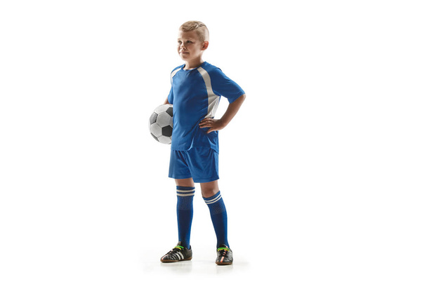 Young fit boy with soccer ball standing isolated on white - 写真・画像