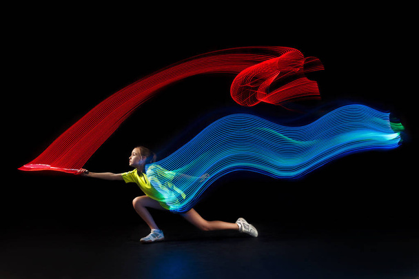 one caucasian young teenager girl woman playing Badminton player on black background - Фото, зображення