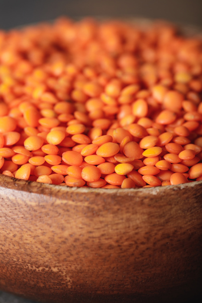 selective focus of red lentils in wooden bowl - Photo, Image