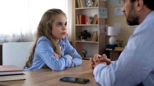 Offended daughter ignoring father, problems with smartphone addiction, conflict - 写真・画像