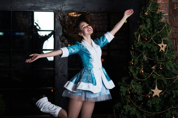 Russian Christmas characters snow maiden. Girl in Christmas costume posing near the Christmas tree - Φωτογραφία, εικόνα