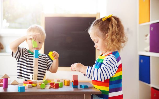 Little children playing with blocks. Boy and girl building towers - Foto, imagen