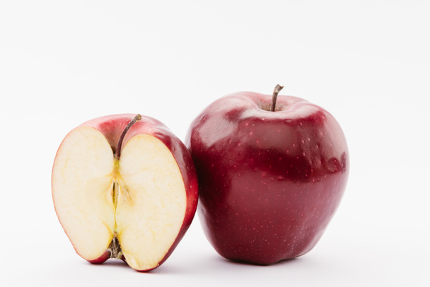 half and whole ripe red delicious apples on white background - Φωτογραφία, εικόνα
