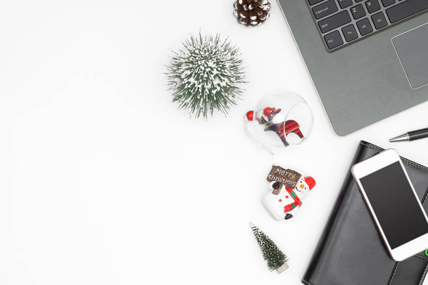 Merry Christmas and Happy new years office work space desktop concept. Flat lay top view with laptop notebook and Christmas ornaments with copy space. - Photo, Image