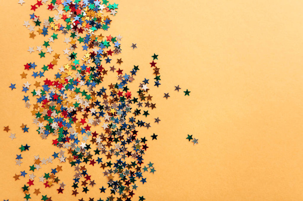 Festive background of multi-colored confetti stars - Fotoğraf, Görsel