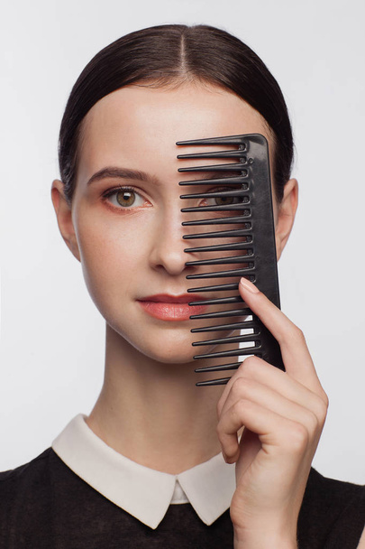 Portrait of beautiful woman with black hair comb - Zdjęcie, obraz
