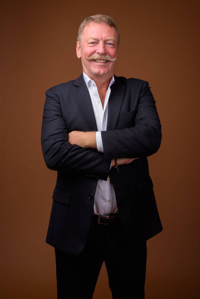 Happy senior businessman with mustache wearing suit - Φωτογραφία, εικόνα