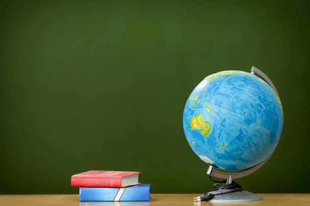 globe with books on the table in the background of school Board - Fotó, kép