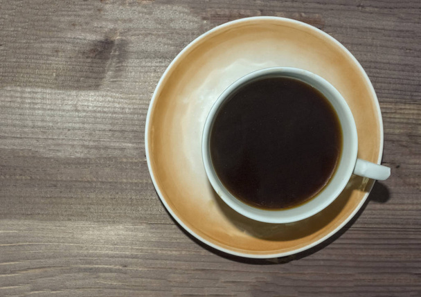 Cup of coffee on dark wooden background. - Foto, Imagem
