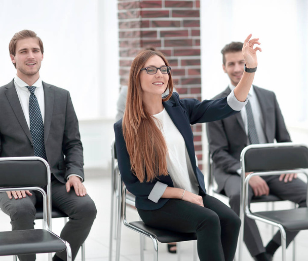 Confident young manager raising hand at workshop - Фото, изображение