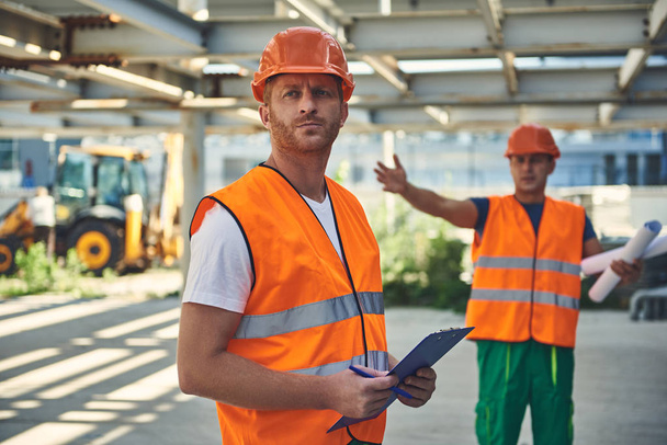 Employees of construction company at working process - Valokuva, kuva