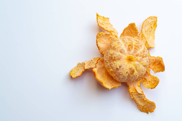 Peeled fresh tangerine on white background - Photo, image