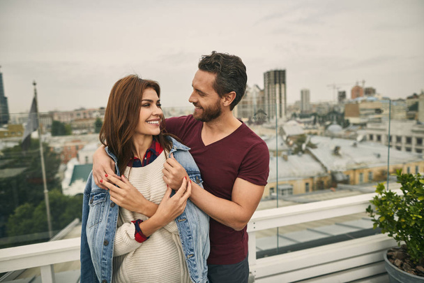 Man and woman are standing on terrace - Valokuva, kuva