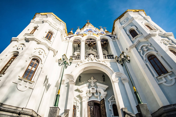 Bells on white church in Kharkov from facade - Fotó, kép