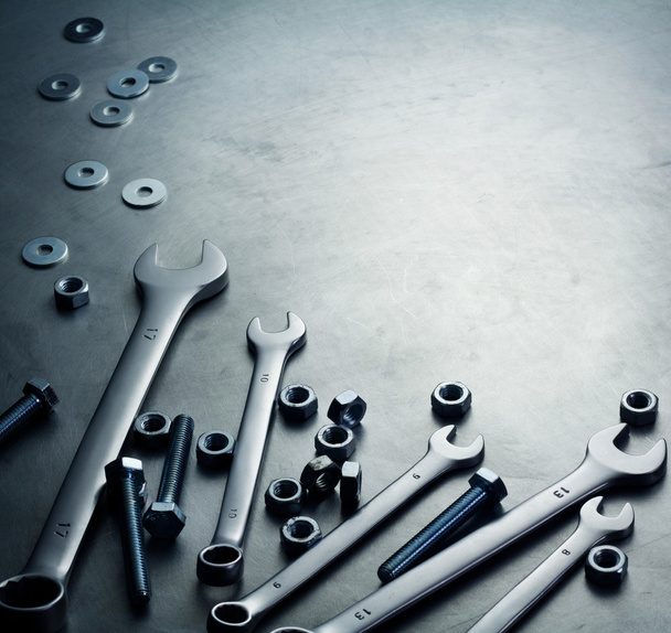Wrenches, nuts and screws on a metal plate - Photo, Image