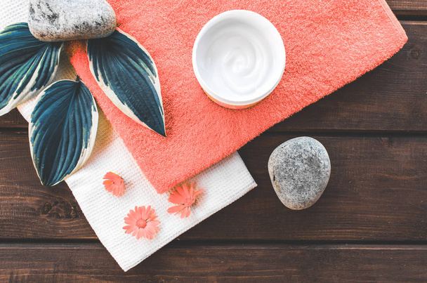 composition top view of bathroom and spa beauty room. Moisturizing and skin care, flowers, cream and natural ingredients, free place . Color of the year 2019 Living coral . COY Livingcoral. - Photo, Image