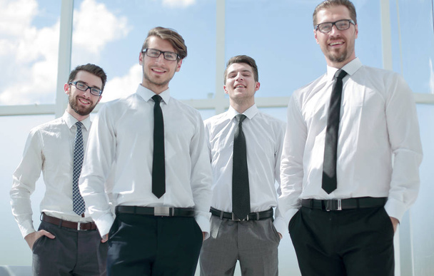 smiling business team standing by the window. - Foto, imagen