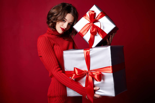 Beautiful sexy young brunette girl with wavy hair bright evening make-up red lips long fluffy eyelashes hold gift box holiday New Year  joy fun happy merry Christmas Eve party celebration. - Foto, Bild