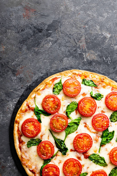 Pizza Margherita with mozzarella cheese, basil and tomatoes Traditional italian food. Classic recipe. Top view - Photo, Image