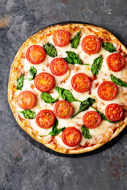Pizza Margherita with mozzarella cheese, basil and tomatoes Traditional italian food. Classic recipe. Top view - Fotoğraf, Görsel