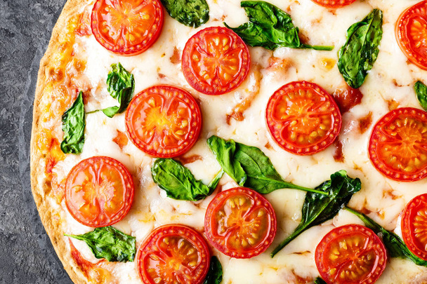 Pizza Margherita with mozzarella cheese, basil and tomatoes Traditional italian food. Classic recipe. Top view - Foto, immagini
