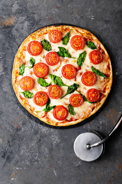 Pizza Margherita with mozzarella cheese, basil and tomatoes Traditional italian food. Classic recipe. Top view - Foto, immagini