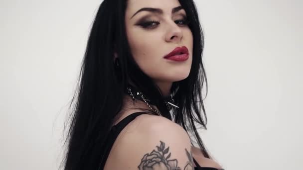 Face of pretty female with big lips, cute blue eyes, long black hair and makeup. - Footage, Video