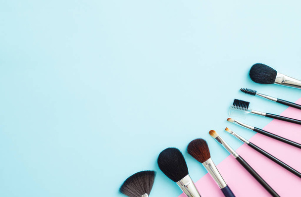 Makeup cosmetic products on blue and pink background - Фото, изображение