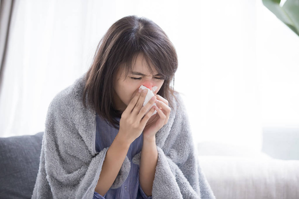 woman sick and sneeze with tissue paper at home - Fotó, kép