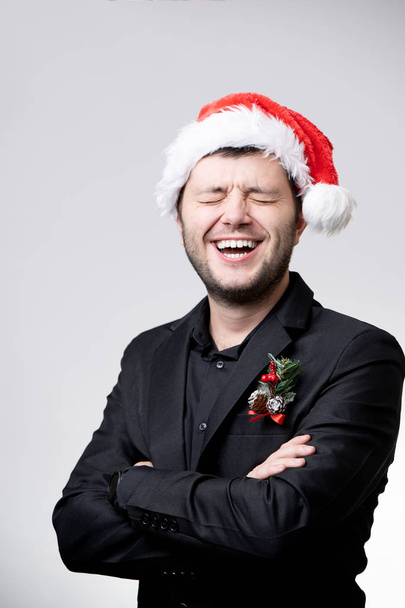 Image of happy brunet in santa cap with arms crossed - Photo, image