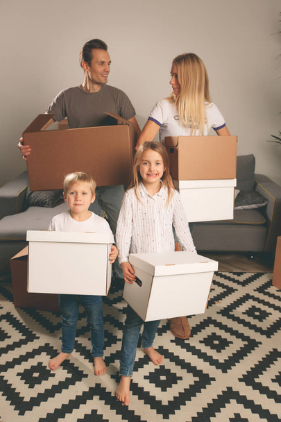 Photo of women, men and children holding cardboard boxes - Photo, Image