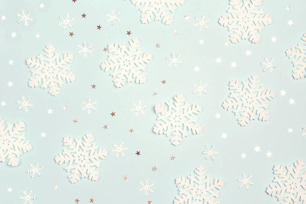 Winter blue background with snowflakes and stars. Flat lay. - Photo, Image