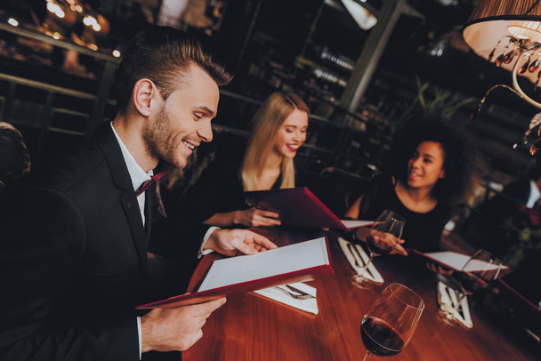 Group Business People Geting Order in Restaurant. Businessmans Having Meeting In Indoor Restaurant. Corporate, Collaboration Concept. Team Professional Worker. Teamwork. Holding Menu. - Photo, image