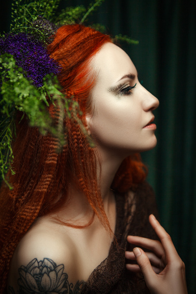 Young redhead model is posing with a creative makeup - 写真・画像