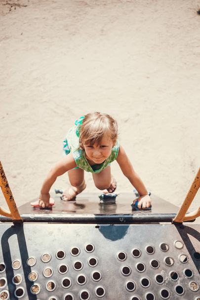 Little girl on the playground in summer. - Foto, Imagen