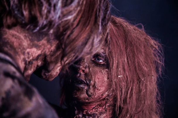 Zombie couple posing together against misty dark background - Foto, Bild
