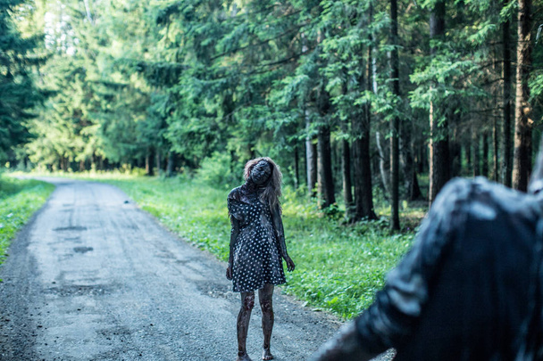 Scary zombie woman posing at forest path - Valokuva, kuva