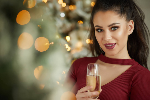 smiling woman holding glass of sparkling wine  - Photo, image