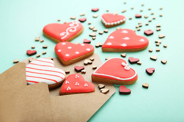 Homemade valentine cookies with envelope on mint background - 写真・画像