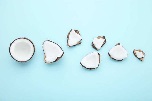 Pieces of coconuts on blue background - Photo, Image