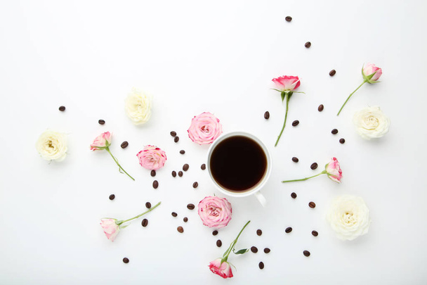 Rose flowers with cup of coffee on white background - Φωτογραφία, εικόνα