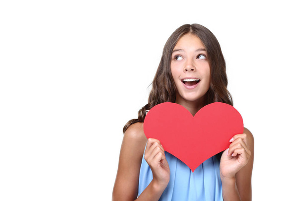 Young girl holding red paper heart on white background - Фото, изображение
