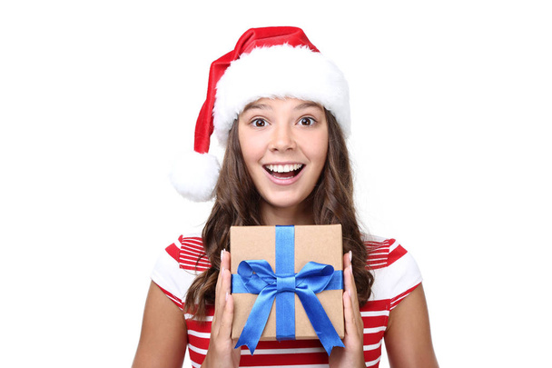 Beautiful girl in santa hat with gift box isolated on white background - Фото, зображення