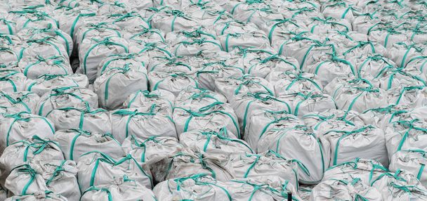 Stacks of white cement bags on construction site. - Foto, Imagem