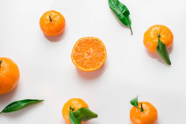 Background of fresh citrus with leaves on white. Flat lay. Top view - 写真・画像