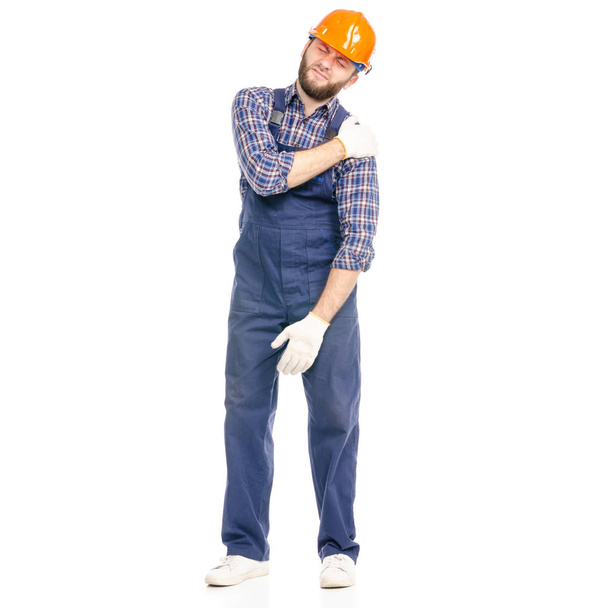 Joven hombre constructor industria trabajador hardhat dolor mano
 - Foto, imagen