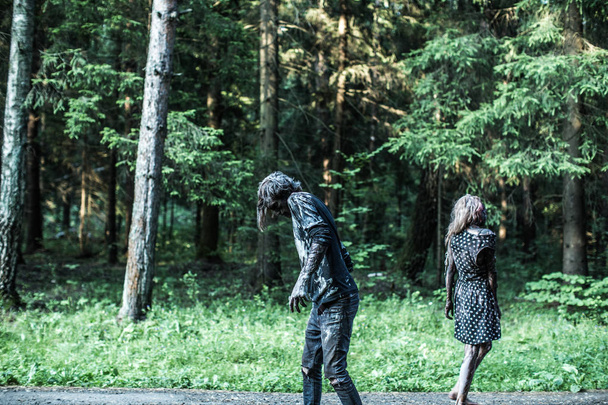 Zombie man and woman posing together at forest - Valokuva, kuva